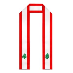 May include: A graduation sash in the colours of the Lebanese flag. The sash has vertical red stripes on a white background, with a green cedar tree emblem on each side. Designed to be worn over the shoulders.