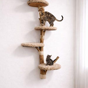 May include: A multi-level cat tree made of natural wood, featuring several circular platforms with plush, beige bedding. Three cats are perched on the tree, with one at the top, one in the middle, and one at the bottom.