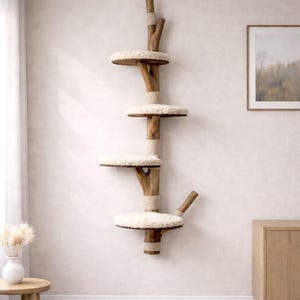 May include: A wall-mounted cat tree with four platforms. The tree is made of natural wood and features round, cream-colored, plush platforms. The central support is wrapped with rope. The cat tree is designed to provide a climbing and resting space for cats.