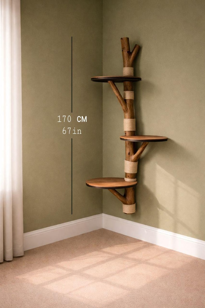 May include: A wooden cat tree with three platforms, attached to a wall. The tree is made of natural-looking branches and has a height of 67 inches (170 cm). The platforms are round and made of wood, and the branches are wrapped with rope.