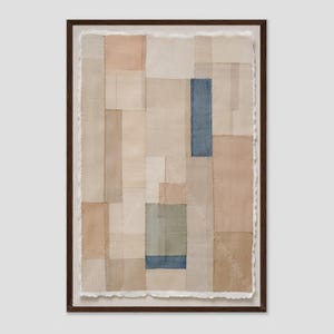 May include: A framed textile wall art piece featuring a patchwork of rectangular fabric panels in neutral shades of beige, tan, and cream, accented by a single vertical blue rectangle and a smaller green and blue block, with raw deckled edges.