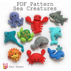 May include: PDF pattern for felt sea creatures. The pattern includes a red crab, a blue whale, a gray manatee, a green turtle, a blue stingray, a red lobster, a blue dolphin, a gray shark, a purple octopus, and a yellow sea urchin.