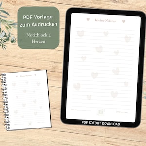 Puede incluir: Una descarga digital con un bloc de notas y un bloc de notas tipo tableta, ambos con páginas rayadas y detalles en forma de corazón. El bloc de notas tiene una encuadernación en espiral, mientras que la tableta tiene un borde negro. El fondo es un veteado de madera clara.