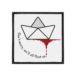 May include: Square patch with a black border. It features a paper boat design with a grey triangle and red dripping blood. The text "Don't worry, we'll all float on" is written in black, curved along the left side.