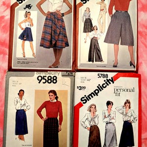 May include: Four vintage Simplicity sewing pattern envelopes. The patterns feature illustrations of women's clothing, including skirts, culottes, and blouses. The envelopes are labeled with sizes, prices, and the Simplicity brand name.