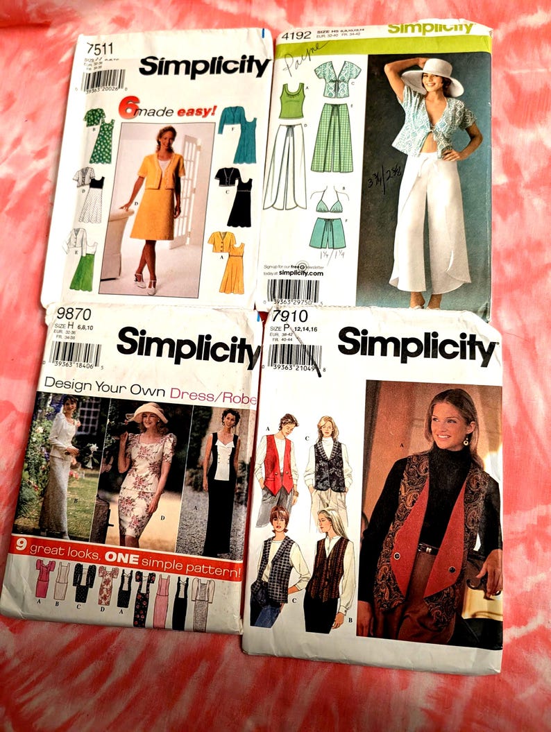 May include: Four vintage Simplicity sewing pattern envelopes. The patterns feature designs for dresses, robes, and separates. The envelopes display images of the finished garments, with text including pattern numbers and sizing information.