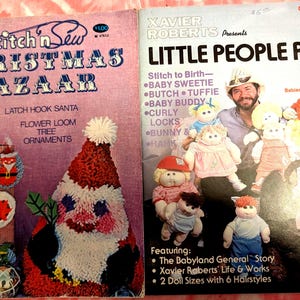 May include: Two vintage magazines are displayed. The left magazine cover reads "1979 Stitch'n Sew Christmas Bazaar" with images of ornaments and a Santa Claus design. The right magazine cover is titled "Little People Pals" by Xavier Roberts, featuring dolls.