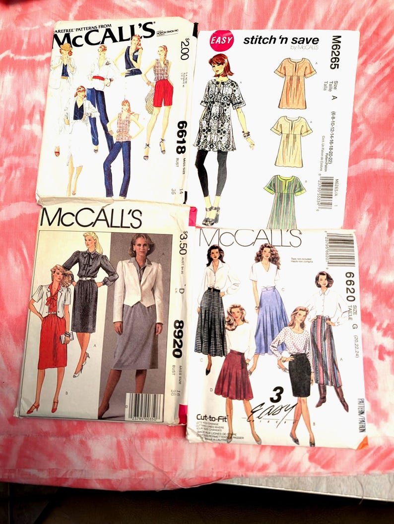 May include: Four vintage McCall's sewing patterns are displayed on a pink and white tie-dye background. The patterns feature illustrations of women's clothing designs, including dresses, skirts, and tops. The patterns are labeled with numbers and the text "Easy stitch 'n save".