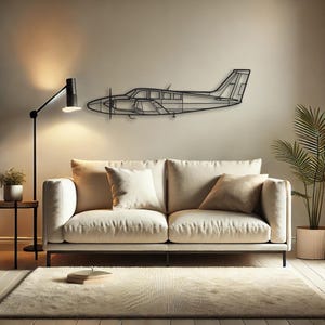 May include: A black metal airplane wall art piece is mounted on a neutral-colored wall above a cream-colored sofa. The room is decorated with a floor lamp, a small side table, and a potted plant, creating a modern living space.