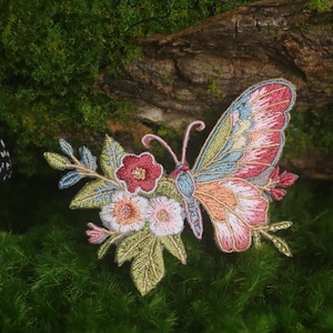 May include: A white ceramic mug with a black handle and the text "But First, Coffee" in a bold, black font. The mug is set against a blurred background, highlighting its clean design.