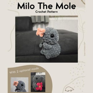 May include: A handmade crocheted grey mole toy, adorned with a peach-coloured flower. The image features the text "Milo The Mole Crochet Pattern" and two optional modifications. The toy is made of soft, plush material and has black eyes. The theme is handmade crafts.