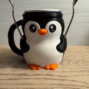 Pebbles the Penguin pint size Ice Cream container holder.