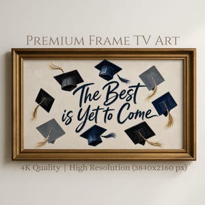 May include: A framed artwork with a gold-colored frame. The artwork features graduation caps in various shades of blue and gray, surrounding the text "The Best is Yet to Come" in navy blue script. The image also includes the text "PREMIUM FRAME TV ART" and "4K Quality | High Resolution (3840x2160 px)".