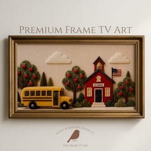 May include: A framed digital art piece titled PREMIUM FRAME TV ART featuring a felt-textured scene of a yellow school bus, a red schoolhouse with a bell tower, an American flag, and apple trees with red fruit against a cream background.