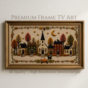 Puede incluir: Un marco dorado rectangular que contiene arte digital de una escena de pueblo otoñal con casas, una iglesia, árboles, calabazas y un gato negro bajo una luna creciente. El texto PREMIUM FRAME TV ART y 4K Quality | High Resolution es visible.