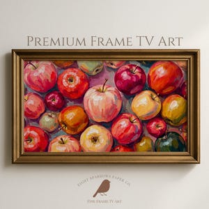 May include: A rectangular digital artwork titled PREMIUM FRAME TV ART featuring a vibrant oil painting of numerous apples in shades of red, yellow, and green. The artwork is displayed within a metallic gold frame, showcasing a dense composition of fruit.