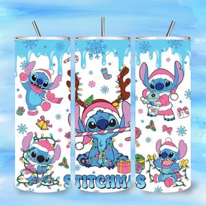 May include: Three stainless steel tumblers with a festive design featuring the character Stitch in various Christmas-themed outfits. The tumblers have a light blue background with snowflakes and the word "Stitchmas". Each tumbler has a silver straw.