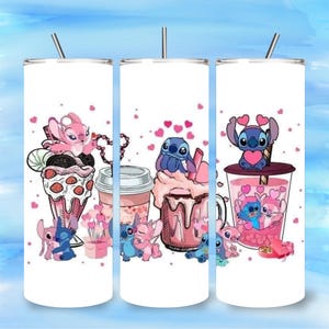 May include: White tumbler featuring cartoon characters Stitch and Angel with pink hearts and desserts. The design includes a milkshake, coffee cup, and a drink with a straw. The tumbler has a silver lid and a straw.