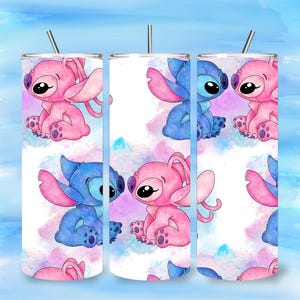 May include: Three stainless steel tumblers with a cartoon design featuring blue and pink alien characters. The tumblers have a white background with a watercolor effect in shades of blue, pink, and purple. Each tumbler has a silver straw.