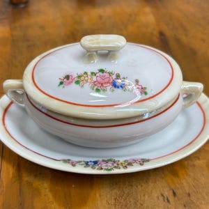 May include: A set of three ceramic mugs with a speckled, matte finish. Each mug features a different color: light blue, cream, and gray. The mugs have a simple, modern design and a comfortable handle.