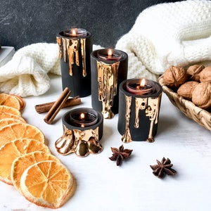 Black and Gold Candle Holders With Dripping Wax