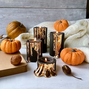 Black and Gold Candle Holders With Dripping Wax