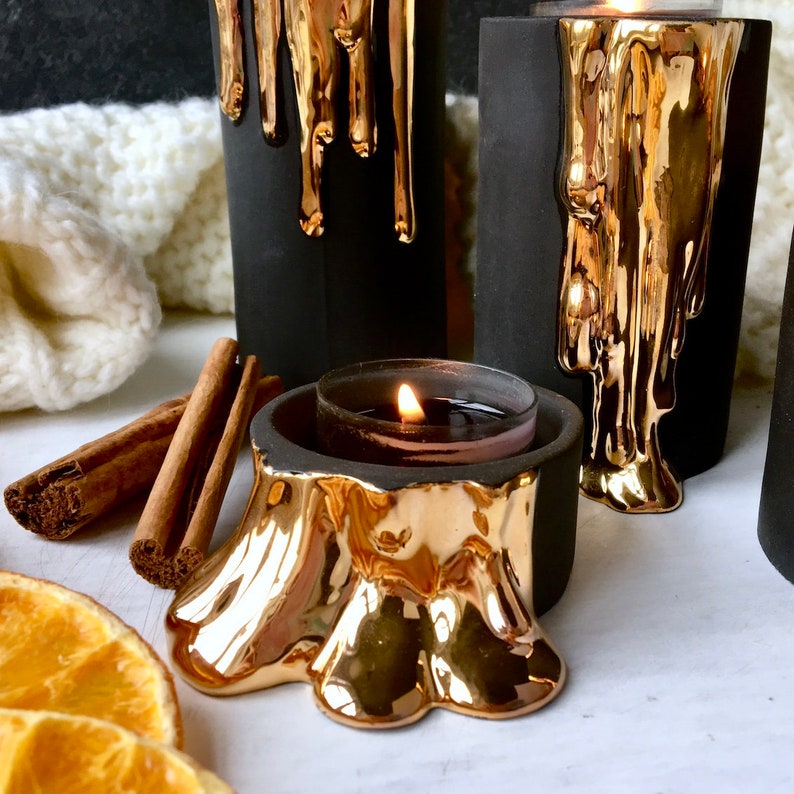 Black and Gold Te Light Holders With Dripping Wax