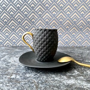 Small Black Textured Coffee Cup with Gold Handle