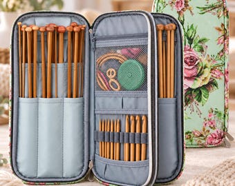 May include: A floral print fabric case containing a collection of wooden knitting needles and crochet hooks. The interior features grey fabric pockets and a mesh compartment holding circular needle cables and a green circular measuring tool.
