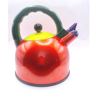 May include: A stovetop tea kettle with a glossy red body, a bright yellow lid, and a dark green arched handle. The kettle features a black knob on the lid, a purple whistle mechanism on the spout, and a black base, creating a multi-colored design.