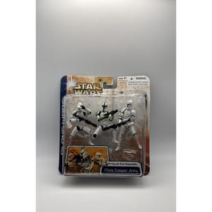 May include: A Star Wars Clone Trooper Army action figure set. The figures are white with black and green accents, holding black rifles. The packaging features the Star Wars logo and the text "Clone Trooper Army."