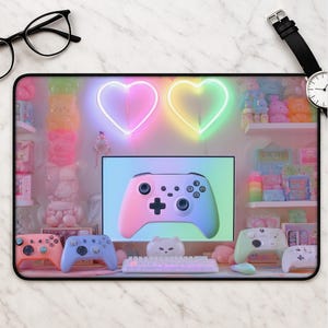 May include: A rectangular desk mat featuring a pastel-colored gaming setup with a gradient controller on a monitor, two neon heart lights, a white keyboard, and several colorful controllers. The scene is surrounded by shelves filled with various toys.