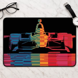 May include: A rectangular mouse pad featuring a stylized graphic of a race car in a split color design. The left side is rendered in shades of blue and teal, while the right side features warm tones of orange, yellow, and red against a black background.
