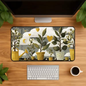 May include: A rectangular desk mat featuring a printed illustration of various potted plants and a yellow watering can. The design includes yellow heart shapes and a crescent moon against a backdrop of white clouds and dark grey foliage.