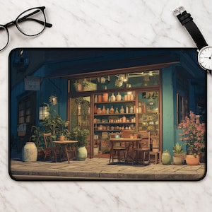 May include: A mousepad featuring an illustrated storefront with a blue facade, wooden tables, and chairs. The shop's interior is filled with various bottles and jars. Potted plants and flowers are placed around the entrance, creating a welcoming atmosphere.
