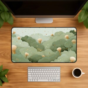 May include: A rectangular desk mat featuring a repeating pattern of soft, sage green cloud-like shapes interspersed with beige makeup brushes and small, scattered gold stars against a light, pale green background.