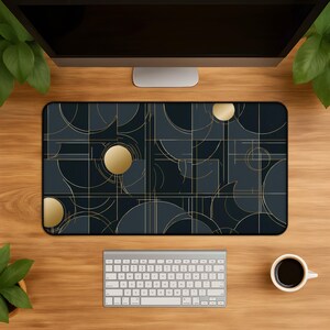 May include: A rectangular desk mat featuring a dark navy blue background with a geometric pattern of thin gold lines and solid gold circles. The design consists of intersecting arcs, straight grid lines, and circular shapes arranged in a balanced layout.