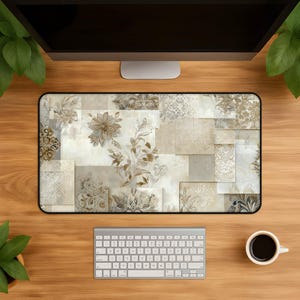 May include: A rectangular desk mat featuring a collage of overlapping square and rectangular tiles in shades of beige, cream, and soft brown. The design includes intricate floral patterns, damask motifs, and subtle leaf illustrations.