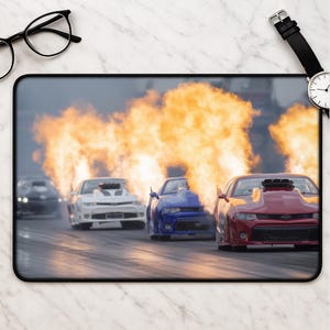 May include: A white ceramic mug with a black handle and the text "But First, Coffee" in a black, bold font. The mug is on a white surface.