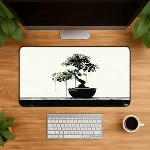 May include: A rectangular desk mat featuring a black and white illustration of a bonsai tree in a dark pot. The tree has detailed black branches and green leaves, set against a plain white background with a dark horizontal base line at the bottom.