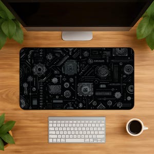 May include: A rectangular desk mat featuring a black background with a white, intricate technical schematic pattern. The design includes various geometric shapes, circular components, and linear markings that resemble a complex circuit board layout.