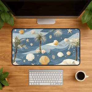 May include: A rectangular desk mat featuring a beach scene with palm trees, seashells, and starfish on a blue background. The design includes white sand, waves, and decorative elements. A keyboard and coffee cup are visible.