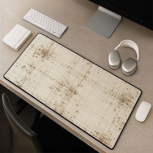 May include: A rectangular desk mat featuring a cream-coloured background with a dark brown, intricate grid pattern of intersecting lines and small circular nodes, resembling a technical blueprint or a complex schematic diagram with a black border.