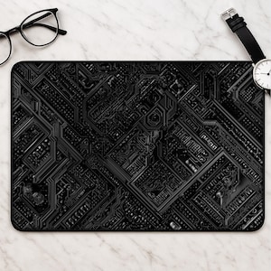May include: A rectangular desk mat featuring a detailed black and dark grey circuit board pattern with intricate lines, geometric shapes, and technical pathways. The mat has a solid black border and a flat, smooth surface texture throughout the design.
