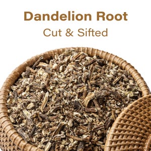 May include: Close-up of a woven basket filled with cut and sifted dandelion root. The text "Dandelion Root Cut & Sifted" is displayed in brown letters above the basket. The dandelion root pieces are a mix of light and dark brown.