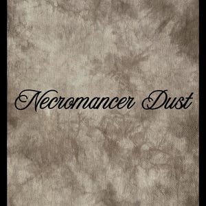 May include: A fabric surface featuring a mottled, tie-dye pattern in shades of brown, tan, and off-white. The text "Necromancer Dust" is printed across the center in a black, cursive, decorative font, standing out against the textured background.