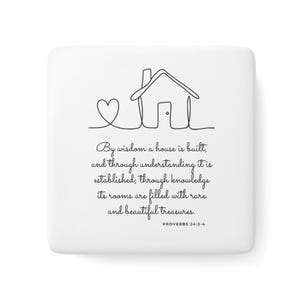 May include: A square white ceramic tile featuring a black line drawing of a house and a heart. Below the drawing is the text: By wisdom a house is built, and through understanding it is established; through knowledge its rooms are filled with rare and beautiful treasures. PROVERBS 24:3-4.