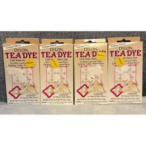 May include: Four boxes of Dylon Tea Dye for fabric, lace, and trims. Each box features a beige and red design with the text "Antique Effects" and "Cold Water Fabric Dye". The boxes are labeled "Colorfast" for natural-fiber fabrics.