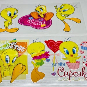 May include: Sheets of cartoon character stickers featuring Tweety Bird in various poses. The stickers include phrases like "You're Sweet!" and "Be My Cupcake." The stickers are yellow, orange, blue, pink, and red.