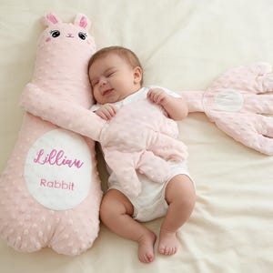 May include: A white ceramic mug with a black handle and the text "But First, Coffee" in a bold, black font. The mug is set against a blurred background, highlighting its clean design.